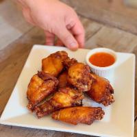 Lemon Thai Wings · Marinated chicken wings with Thai herbs, served with sweet chili sauce. 7 pieces.