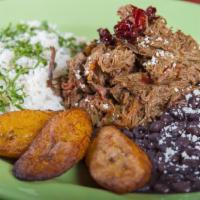 Ropa Vieja · Shredded beef sauteed with onions, green peppers, and tomatoes served with black beans, whit...