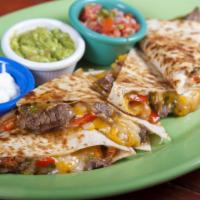Steak Quesadilla · Griddled flour tortilla, chihuahua cheese, roasted peppers, chile rajas, and onions, served ...