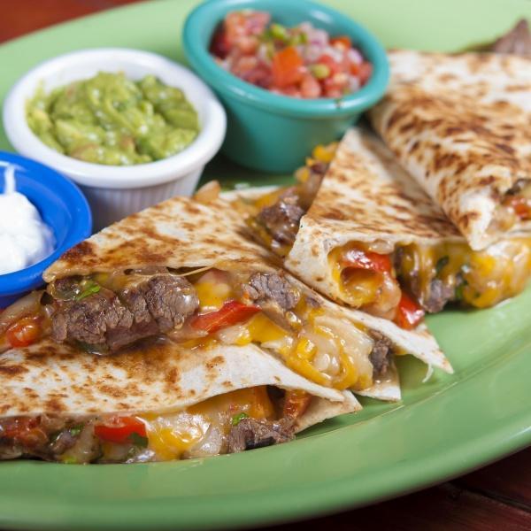 Steak Quesadilla · Griddled flour tortilla, chihuahua cheese, roasted peppers, chile rajas, and onions, served with side of pico de gallo, guacamole and sour cream.