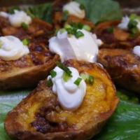 Loaded Skins · Potato skins, bacon, cheddar, sour cream cream and green onion.