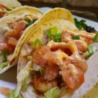 Baja Shrimp Tacos · 3 blackened shrimp tacos, pico de gallo, shredded lettuce and Sriracha aioli served with ric...