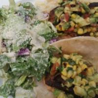 Blackened Mahi Mahi Tacos · Blackened mahi tacos topped with roasted corn-avocado salsa. Served with Caesar or seasonal ...