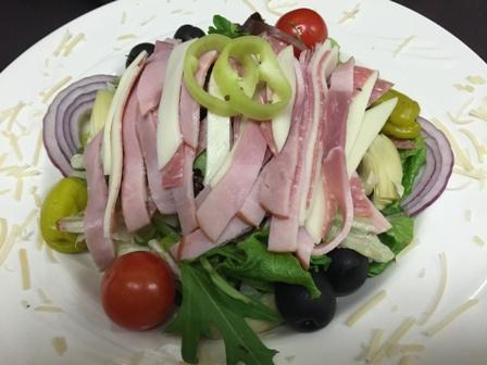 Antipasto Salad · Fresh, crisp mixed lettuce topped with ham, salami, provolone cheese, black olives, tomatoes, onions and pepperoncinis. Served with homemade Italian dressing. Served with rolls and butter.