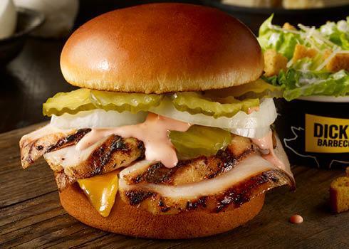 Barbecue Ranch Bird Sandwich · Tender smoked marinated chicken with sweet and tangy barbecue ranch sauce, cheddar cheese, crisp onions, and pickles on a toasted bun.