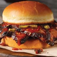 Texas Hot Brisket Sandwich · Chopped or sliced smoked brisket topped with our Texas Hot Sauce and jalapeños, stacked on a...