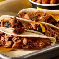 Brisket & Cheese Taco · Slow smoked chopped brisket, cheddar cheese on a flour tortilla