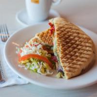 Chicken Pesto Panini · Chicken breast, grilled onions, and sun-dried tomatoes. Served with chips.
