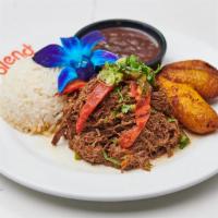 Cuban Braised Beef · Braised beef with peppers, tomato and onions. Served with rice, beans and sweet plantains.