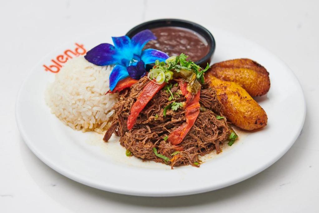 Cuban Braised Beef · Braised beef with peppers, tomato and onions. Served with rice, beans and sweet plantains.