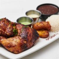 Half Chicken · Peruvian style rotisserie chicken served with rice, beans and sweet plantains.