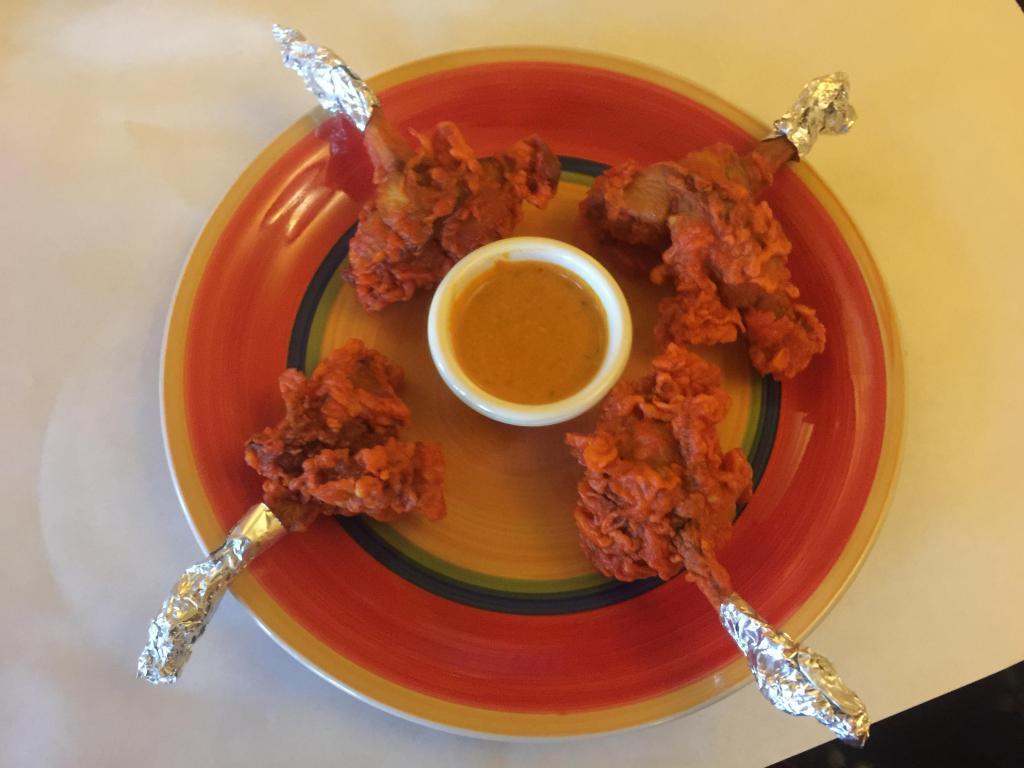 CHICKEN LOLLIPOP- appitizer · A Chicken wings coated in tasty corn flour batter,mixed with Indian spices and deep fried . Served with home made tomato chilli chutney.