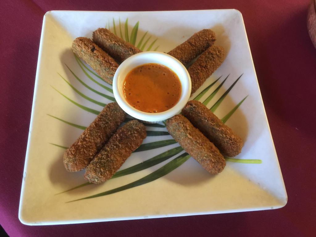 Spinach Rolls (8 Pcs) · Fresh spinach greens and paneer cheese rolled into a delcious snack. Served with homemade roasted tomato and chilli chtuney.  Must try!!.