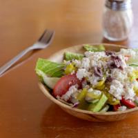 Greek Salad · Crisp romaine lettuce, Roma tomatoes, cucumbers, red onions and pepperoncini topped with cru...