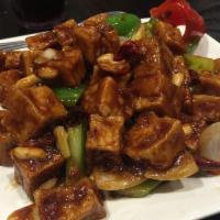 Kung Pao Chicken · Dark meat chicken sauteed with bell pepper and onion in a spicy brown sauce with peanuts. Sp...