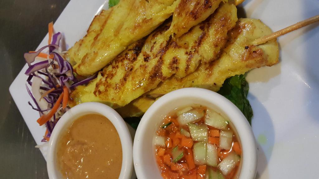 2. 4 Piece Satay Chicken · Marinated in coconut cream with herbs and spices grilled served with peanut sauce and cucumber sauce.