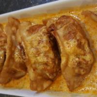 6. 6 Pieces Pot Sticker · Dumpling with panang curry sauce. Delicate vegetarian and chicken filled dumplings served in...