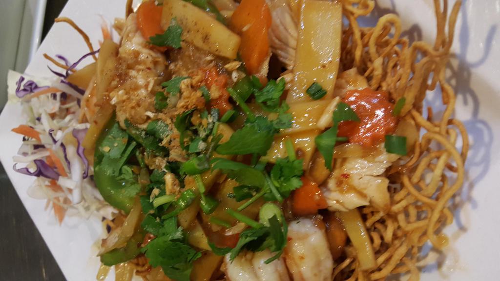 63. Leela Thai Basket · Crispy noodle basket topped with shrimp and chicken, bell pepper, cashew nut, bamboo shoot, onion with our homemade spicy sauce. Served with steamed rice. Spicy.