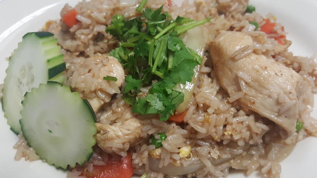 14. Thai Fried Rice · Carrot, peas, onion, napa cabbage and egg. Served with steamed rice.