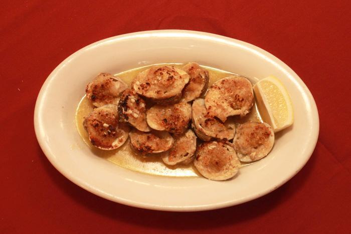 Baked Clams · Fresh clams on a half shell topped with seasoned bread crumbs.