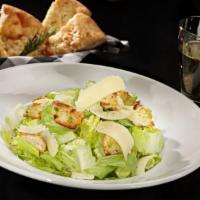Classic Caesar Salad · Crisp romaine hearts, homemade croutons, our classic Caesar dressing and shaved Parmesan che...