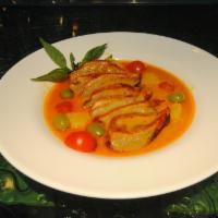 Gaeng Ped Yang · Homemade roasted duck cooked in red curry with pineapple, tomatoes and grapes. Served with T...