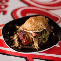 Paleo Dog · Bacon wrapped Portuguese sausage with chili, grilled onions, peppers, pastrami, pastrami, an...