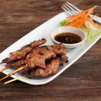 Moo Pingหมูปิ้ง · Grilled marinated pork on a stick served with spicy home made sauce.