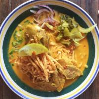 N13. Khao Soi Noodle ข้าวซอย · Egg noodles with chicken legs in creamy coconut yellow curry soup, scallion, red onion, pick...
