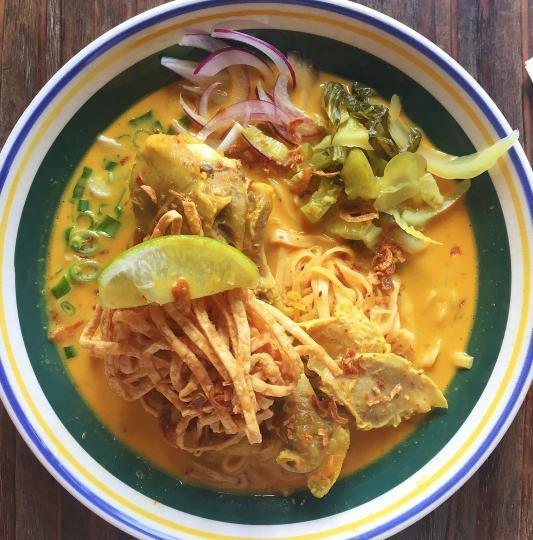 N13. Khao Soi Noodle ข้าวซอย · Egg noodles with chicken legs in creamy coconut yellow curry soup, scallion, red onion, pickled mustard greens and cilantro, Spicy.