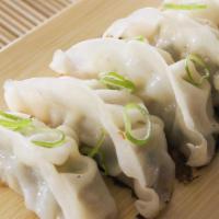 Steamed Dumplings · A mixture of pork and cabbage dumplings. Steamed.