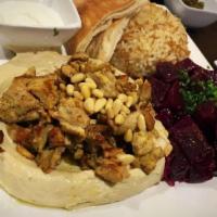 Hummus with Chicken Shawarma · Hummus, chicken shawarma, pine nuts and olive oil.