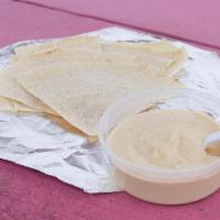 Hummus with Pita Bread · A vegetarian dish made from cooked, mashed chickpeas blended with tahini, olive oil, lemon j...
