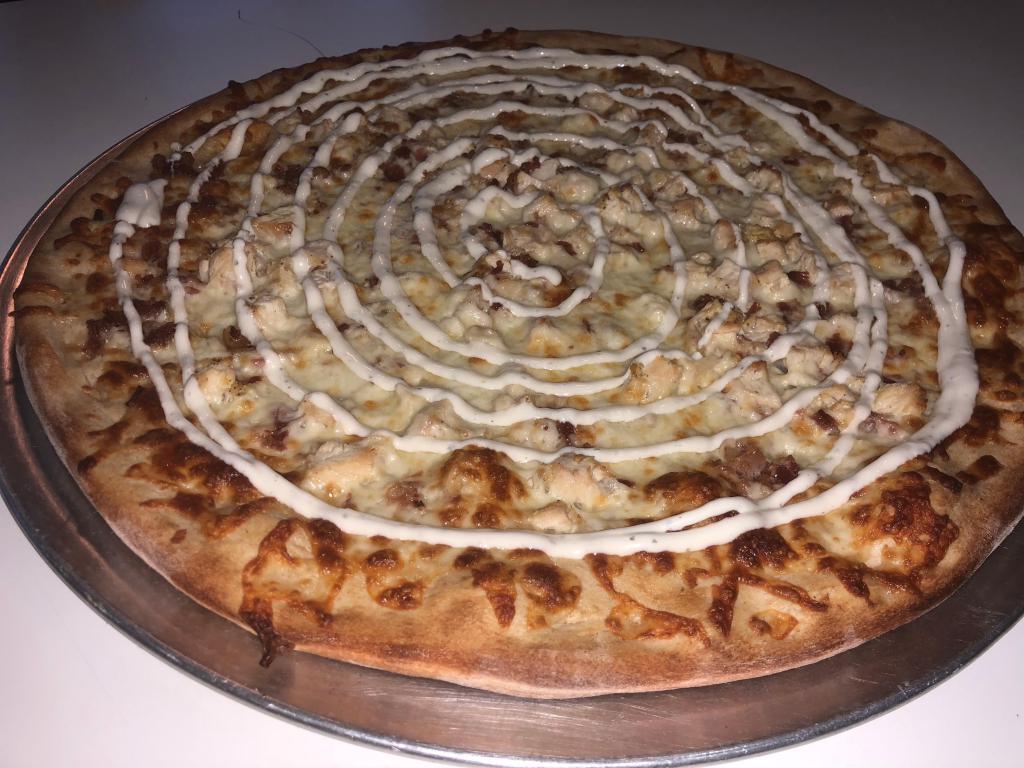 Chicken Ranch Bacon Pizza · Marinated grilled chicken with bacon and ranch dressing and a blend of cheeses.
