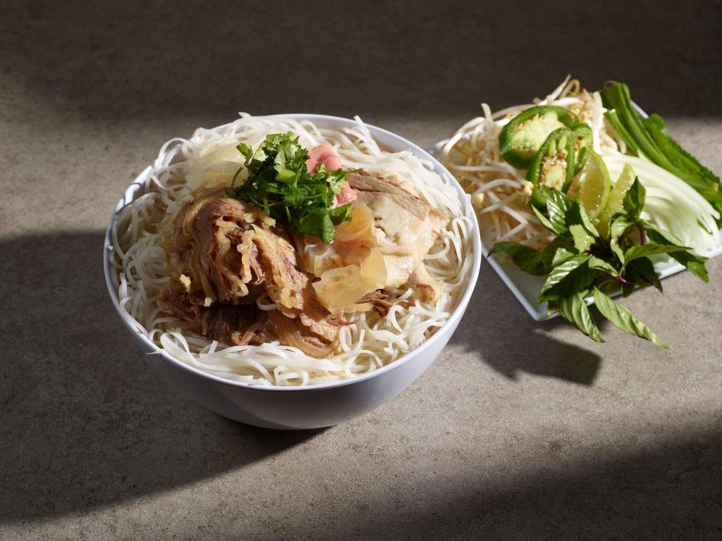 P1. Pho Dac Biet · House special combo pho . combination of rare beef slice, well done brisket, flank, tendon and tripe.
