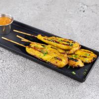 Chicken Satay · Marinated, then grilled on skewers and served with peanut sauce and cucumber sauce.