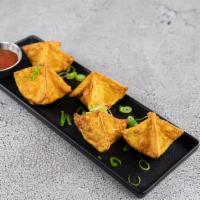 Crab Rangoon · Cream cheese mixed with crab meat, wrapped in wonton skin, and then deep-fried.