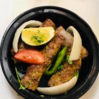 A12. Kabob Grilled · Ground lamb or chicken rolls with fresh green herbs and spices.