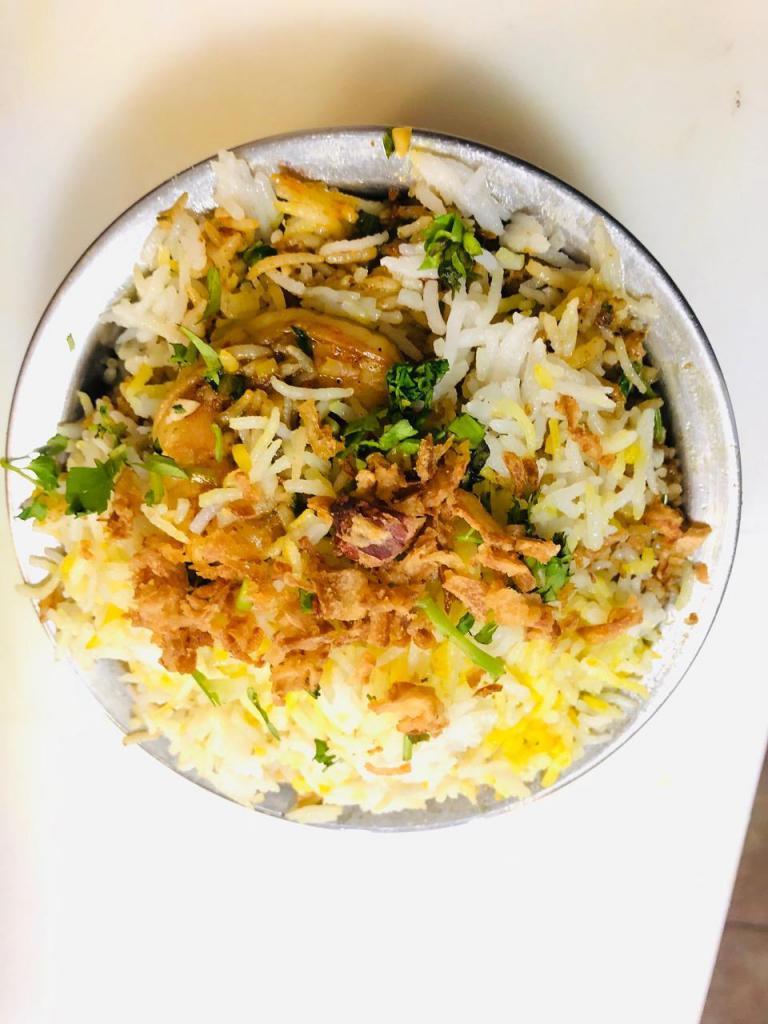 R5. Shrimp Biryani · Cooked aromatic basmati rice, richly flavored saffron, herbs and spices. Served with raita. Gluten free.