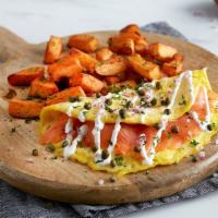 Smoked Salmon Omelet · Three eggs, cold-smoked Atlantic salmon, diced red onions, capers and sour cream sauce. Serv...