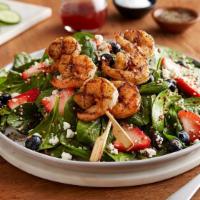 Berry Spinach & Shrimp Quinoa Salad · Two skewers of grilled shrimp, fresh strawberries, blueberries, feta and quinoa on baby spin...