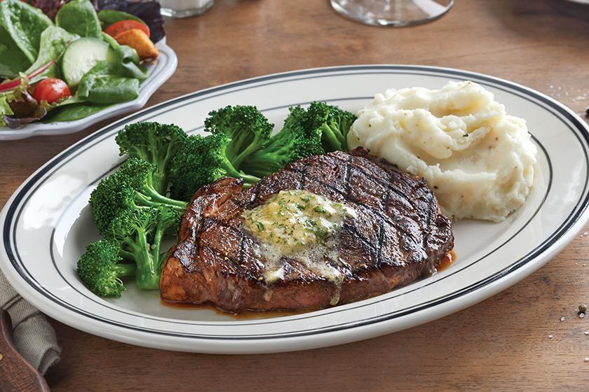 Ribeye Steak · 28-day aged, 10 oz. USDA Choice ribeye steak. House-made herb butter available upon request, your choice blackened or grilled. Served with choice of two sides.