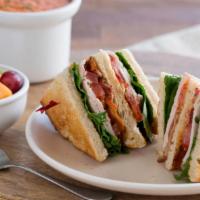 Roasted Turkey Club · Triple decker of slow-roasted turkey, bacon, lettuce, tomato, and mayonnaise on toasted sour...