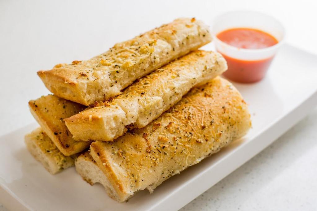 Bread Sticks · Freshly baked and topped with extra virgin olive oil, herbs and cheese.