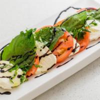 Caprese Salad · Sliced mozzarella and plum tomatoes with fresh basil in a balsamic reduction.