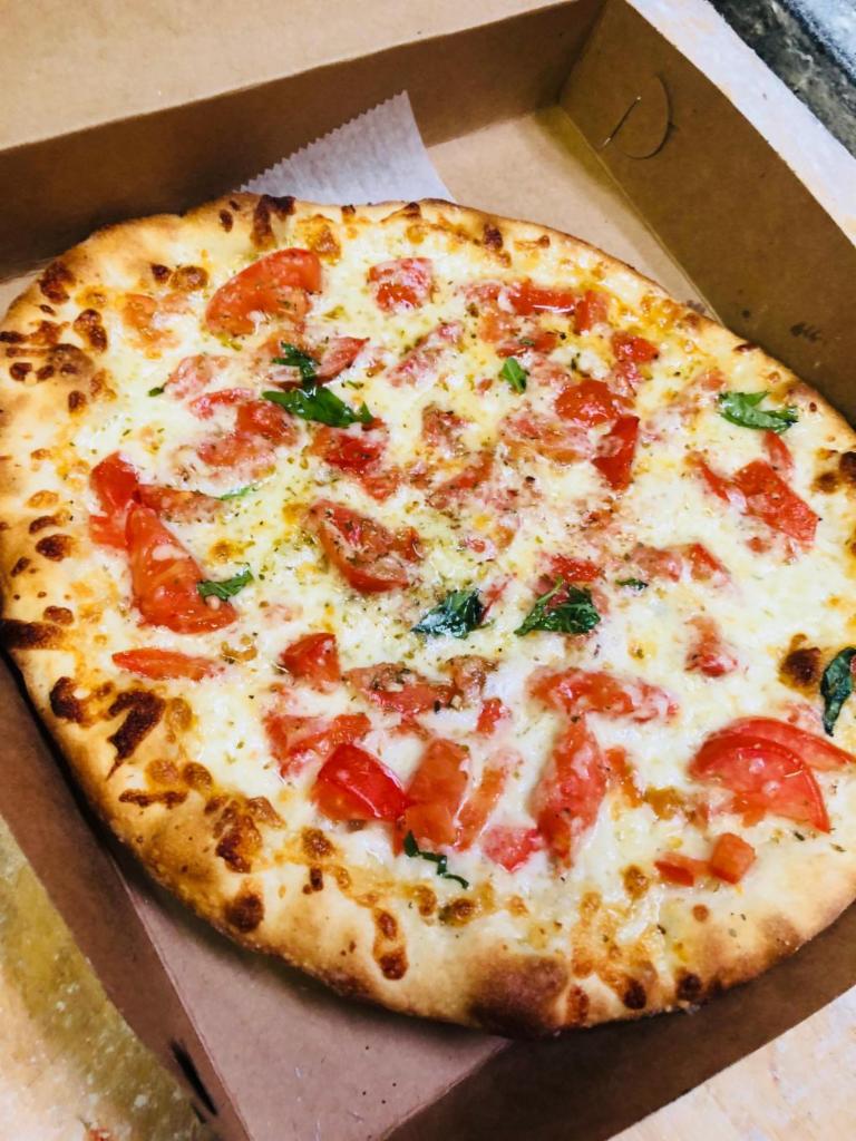 Italian Style Personal Pizza · Fresh tomato, oregano, olive oil and basil. No tomato sauce.