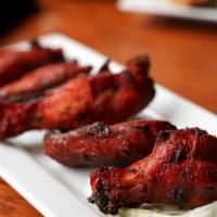 Tandoori Wings · Chicken wings marinated and baked in clay oven. Spicy.