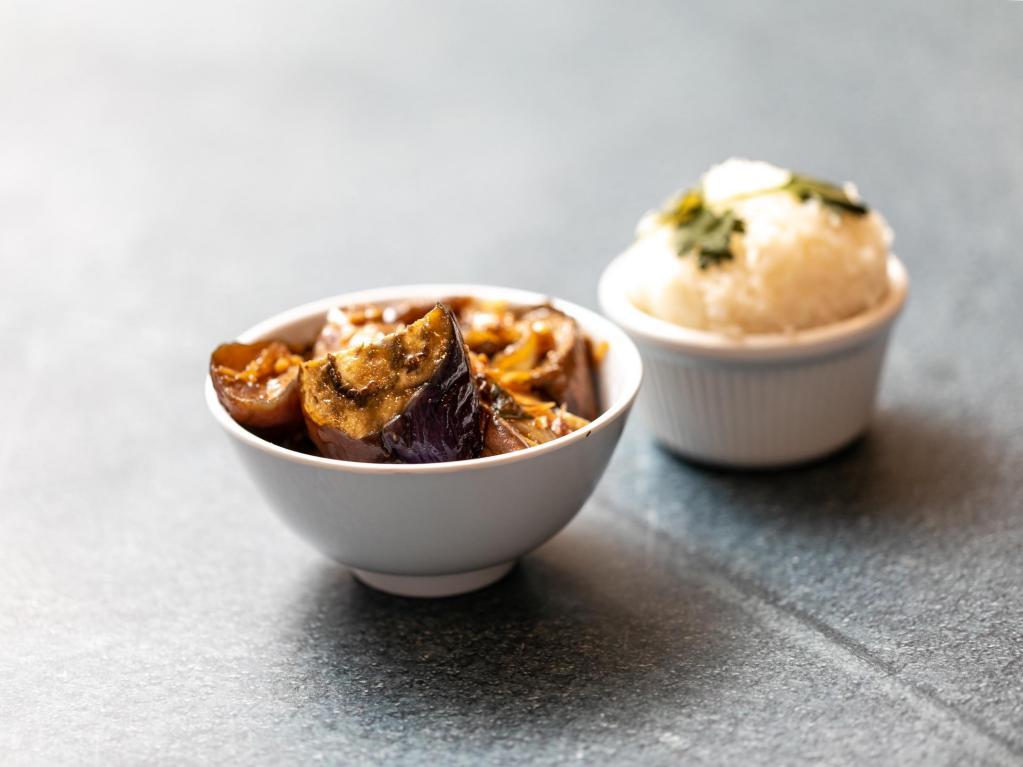 Eggplant Clay Pot · Asian eggplant braised in shallot soy sauce, with onion, garlic and black pepper, served with jasmine rice. Veggie.