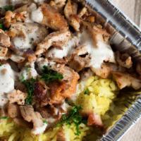 Chicken Shawarma Plate · Contains Rice, hummus, garlic, tahini, dolma topped with Parsley with 1 side: Choose Pita an...