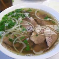 91. Pho Bo 越南粿条牛肉汤面 · Vietnamese beef noodle soup with slicedd beef and onion served with hoisin sauce, lemon, bas...